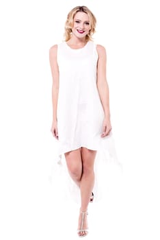 Elegant woman wearing white dress and posing