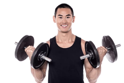 Image of smart young man lifting dumbbells