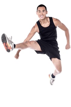 Handsome athlete before workout, stretching legs