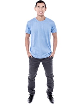 Smiling young man standing on white background