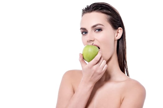 Young woman posing to camera while eating apple
