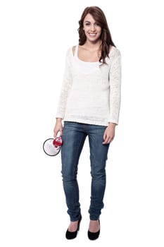 Woman holding loudhailer standing on white background