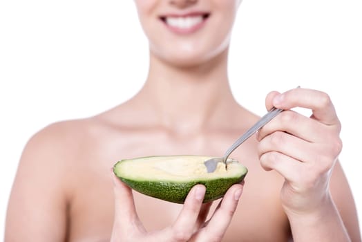 Cropped image of a woman eating avocado