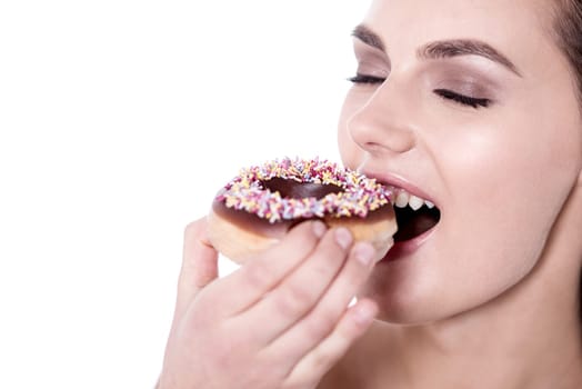 Young woman enjoying her snack against white