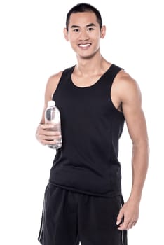 Young sports man posing with water bottle.