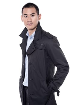 Handsome model posing to camera with hands in pockets