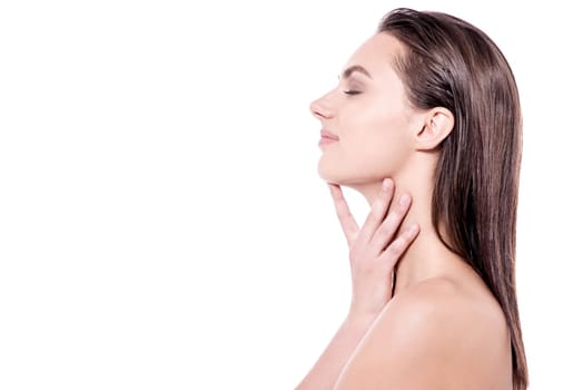 Young spa woman posing in sideways over white