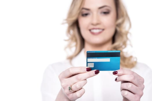 Smiling woman reading her credit card