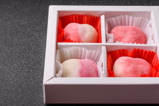 Delicious sweet mochi in the shape of red hearts for the holiday of Valentine's Day
