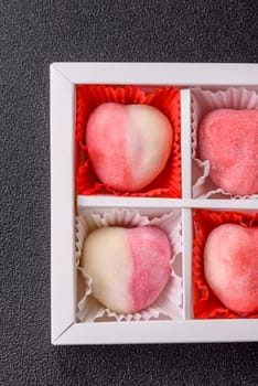 Delicious sweet mochi in the shape of red hearts for the holiday of Valentine's Day