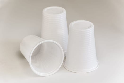 threee plastic glasses on a white plain