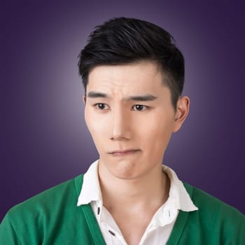 Funny facial expression, closeup Asian young man.