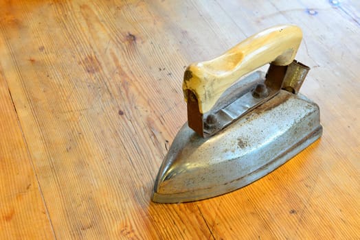 Old electrical iron on an old wooden table
