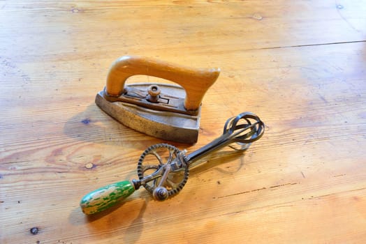 Old iron and mixer on an old wooden table