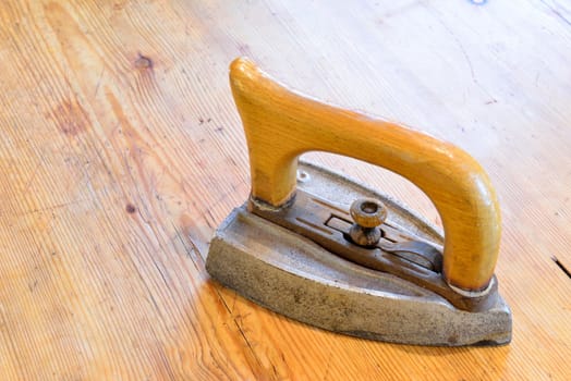 Old iron on an old wooden table