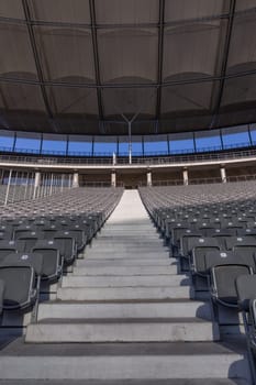 Staircase between rows of chairs in a stadium