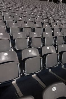 Rows of seats made of folding chairs in stadium