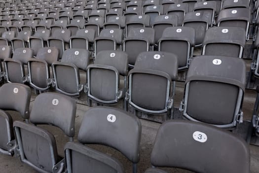 Numbered folding chairs in a stadium