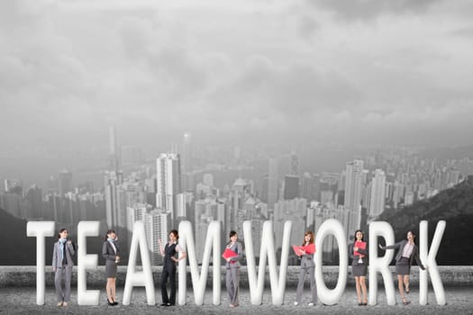 Concept of teamwork with group of business people stand with 3d text.
