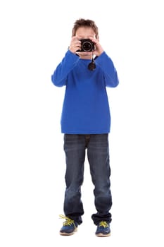 six years old boy taking photos with his camera on white background
