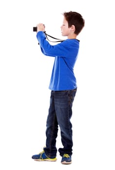 six years old boy taking photos with his camera on white background