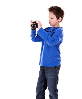 six years old boy taking photos with his camera on white background