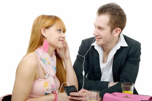 a young couple listening to music with smarphone, on white