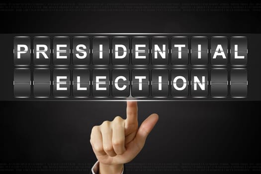 business hand pushing presidential election on Flipboard Display