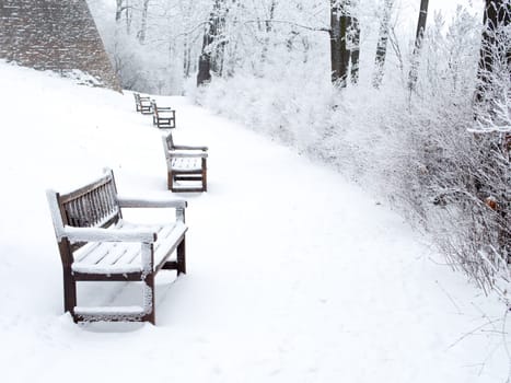 Detail of weathered wooden bench covered in snow, winter time illustration