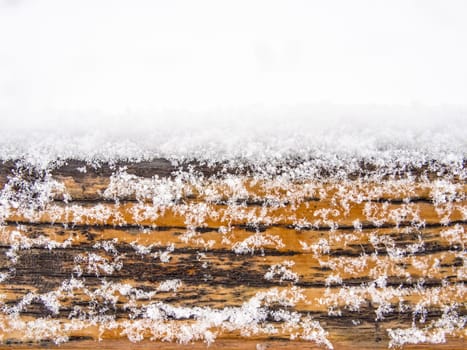 Detail of weathered wooden bench covered in snow, winter time illustration