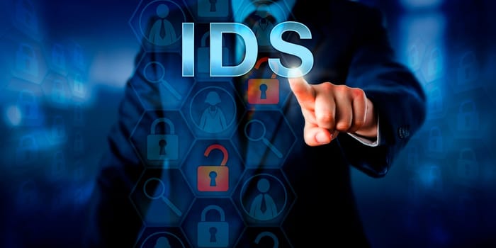 Corporate network administrator pushing IDS on a touch screen interface. Business and information technology concept for Intrusion Detection System monitoring for policy violations and cyber attacks.