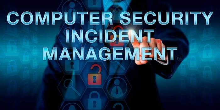 Man is pressing COMPUTER SECURITY INCIDENT MANAGEMENT on a touch screen interface. business metaphor and information technology concept for monitoring security events on a computer system or network.