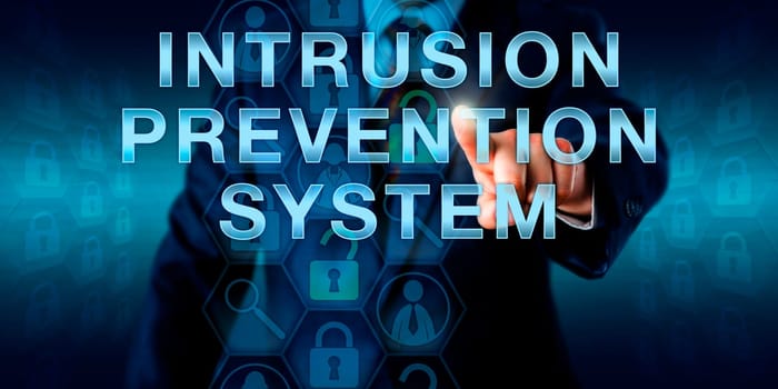 Cybersecurity specialist is touching INTRUSION PREVENTION SYSTEM onscreen. Information technology and security concept for an IPS set of network protection appliances monitoring system activities.