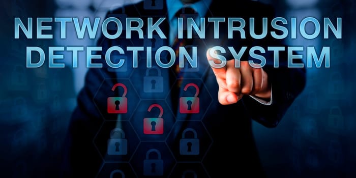 Administrator is pushing NETWORK INTRUSION DETECTION SYSTEM on a touch screen interface. Business metaphor and information technology concept for software monitoring a computer network for attacks.