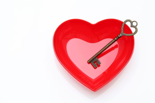 vintage key and red heart on white background