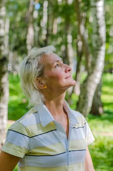 Portrait of the woman in a birch wood