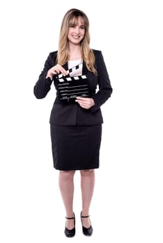 Business lady holding clapperboard. Shot on white background