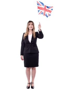 Full length image of businesswoman holding british flag