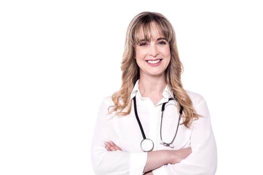 Confident female doctor with crossed arms over white.