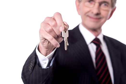 Blurred image of senior businessman holding house key