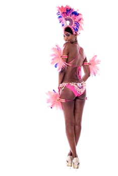 Back view of a young woman dancer in action with hands on hips