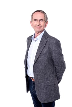 Handsome senior posing to camera with folding arms at back