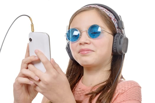 A preteen girl listening to music with his smartphone, on white
