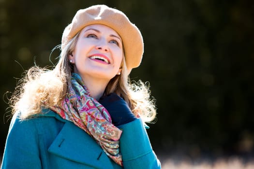 blond casual woman happy outdoors in the park