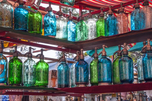 BUENOS AIRES - JUNE 26, 2011. San Telmo flee market, one of the most famous tourist place in Buenos Aires. Vintage bottles for sale on June 26, 2011 in Buenos Aires