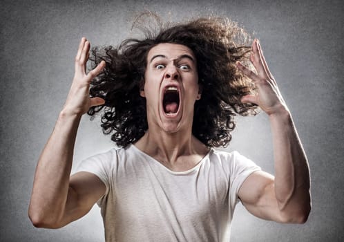 Young guy facing a mental collapse with a desperate expression