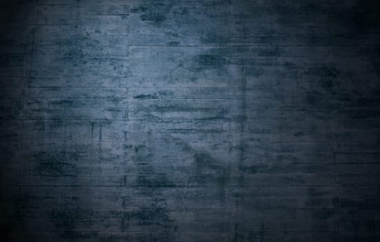 Old weathered rustic blue grey stone wall as cool uneven background with lots of spots and scratches
