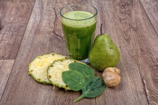 Blended fruit smoothie with ingredients on wooden table