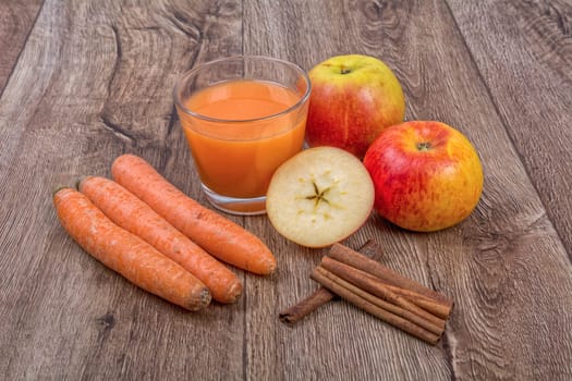 Blended fruit smoothie with ingredients on wooden table