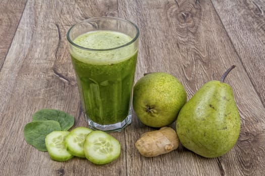 Blended fruit smoothie with ingredients on wooden table